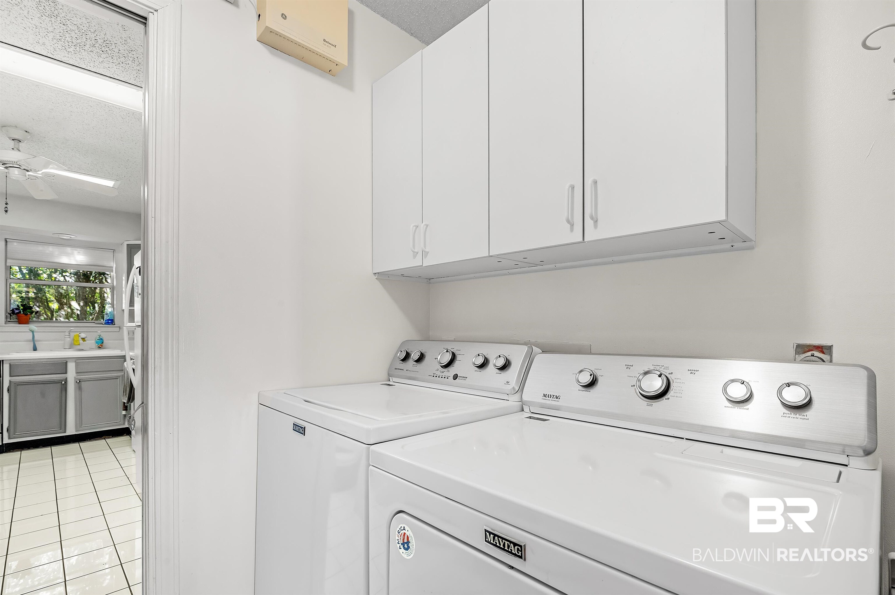 526 Ariel Avenue Foley, AL 36535 - Photo 19 of 33 Washroom featuring cabinets, a wall mounted air conditioner, a textured ceiling, ceiling fan, and washer and clothes dryer