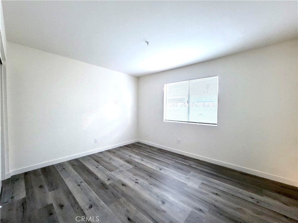 402 North Curtis Avenue, Unit A Alhambra, CA 91801 - Photo 11 of 12 an empty room with wooden floor and windows