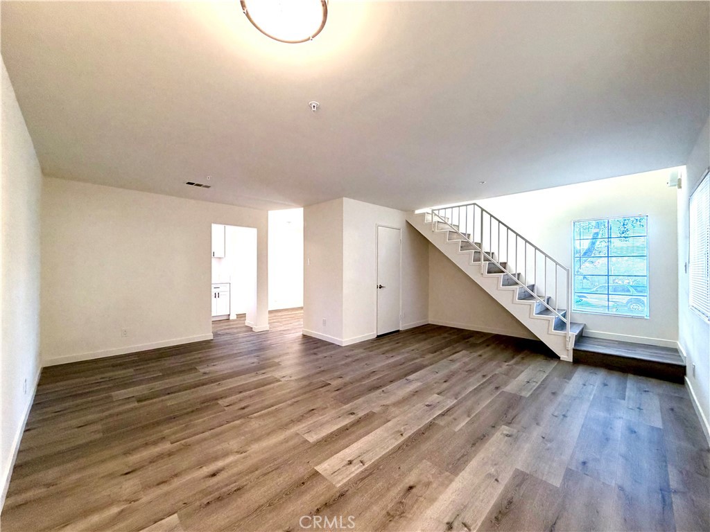 402 North Curtis Avenue, Unit A Alhambra, CA 91801 - Photo 2 of 12 a view of an empty room with wooden floor and stairs