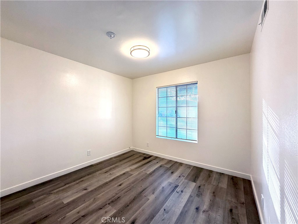 402 North Curtis Avenue, Unit A Alhambra, CA 91801 - Photo 4 of 12 an empty room with wooden floor and windows