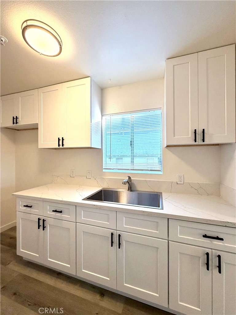 402 North Curtis Avenue, Unit A Alhambra, CA 91801 - Photo 6 of 12 a kitchen with white cabinets and a sink