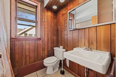 a bathroom with a sink a toilet and a window