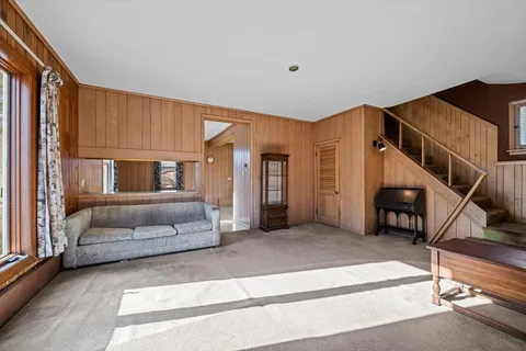 a bedroom with furniture and a staircase