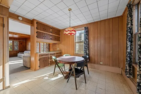 a view of a room with a table and chairs