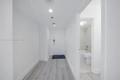 a view of a room with wooden floor and a toilet