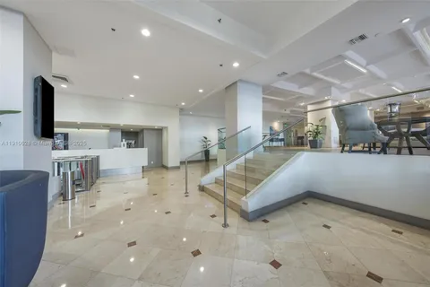 a lobby with furniture and a flat screen tv