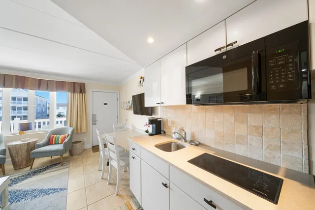 a kitchen with stainless steel appliances a stove microwave and sink