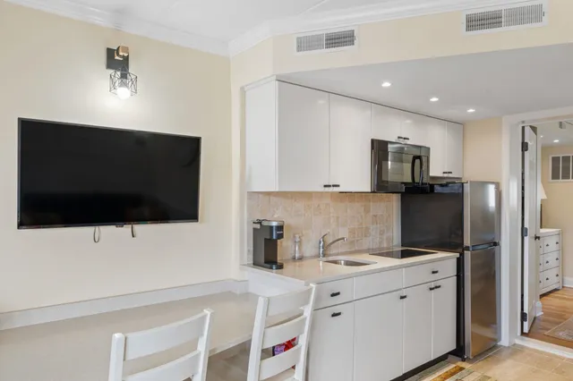 a kitchen with a sink stainless steel appliances and cabinets