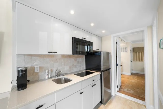a kitchen with a sink and refrigerator