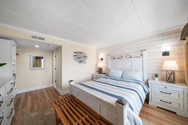 a bedroom with a bed and a lamp