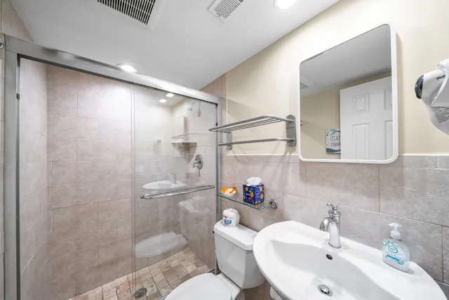 a bathroom with a sink toilet and shower