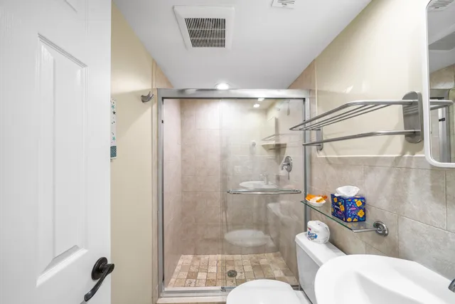 a bathroom with a shower a toilet and a shower