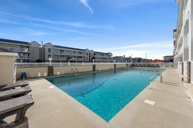 a view of a swimming pool with a lawn chairs
