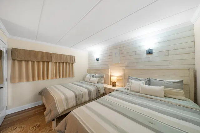 a bedroom with beds and a night stand