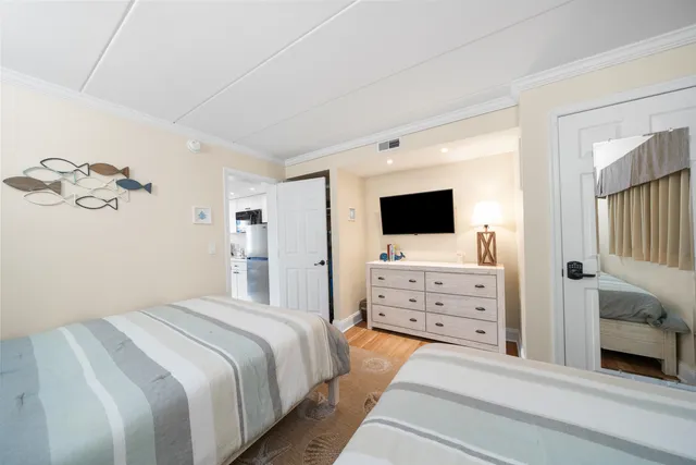 a bedroom with a bed and flat screen tv