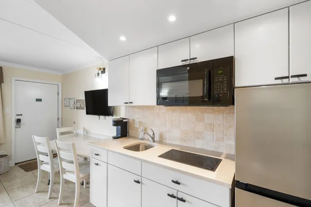 a kitchen with a sink cabinets and stainless steel appliances