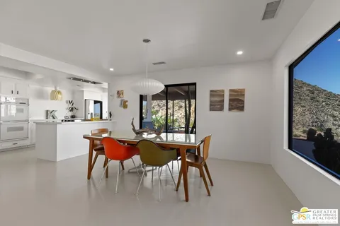 a dining room with furniture and window