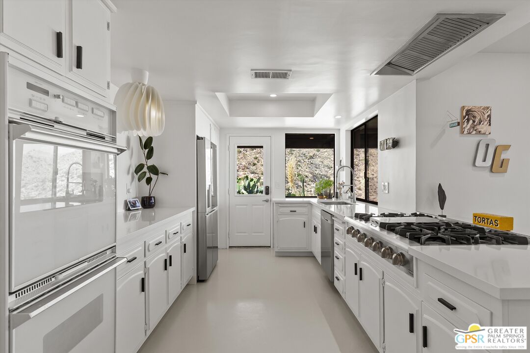 53744 Ridge Road Yucca Valley, CA 92284 - Photo 16 of 39 a kitchen with stainless steel appliances a sink stove and refrigerator