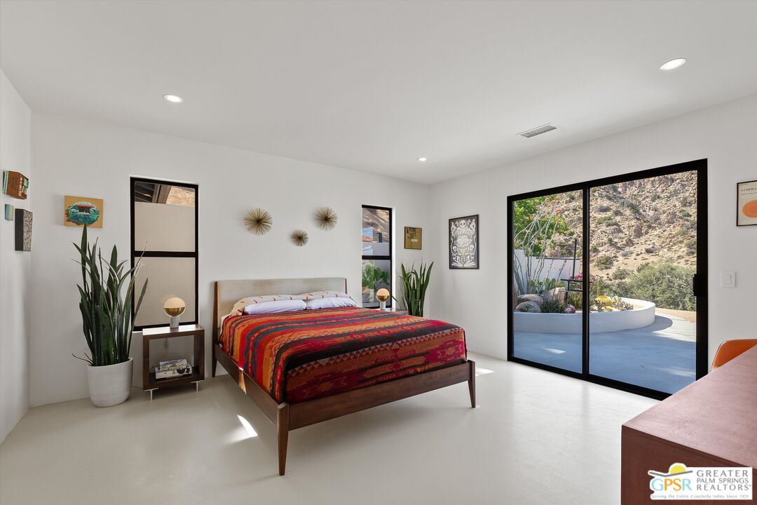 53744 Ridge Road Yucca Valley, CA 92284 - Photo 20 of 39 a bedroom with a large bed and a window
