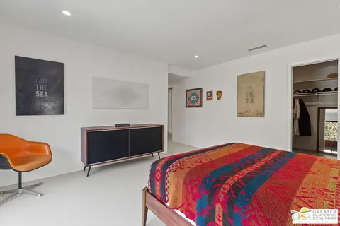 a bedroom with a bed and dresser