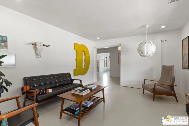 a living room with furniture and a mirror