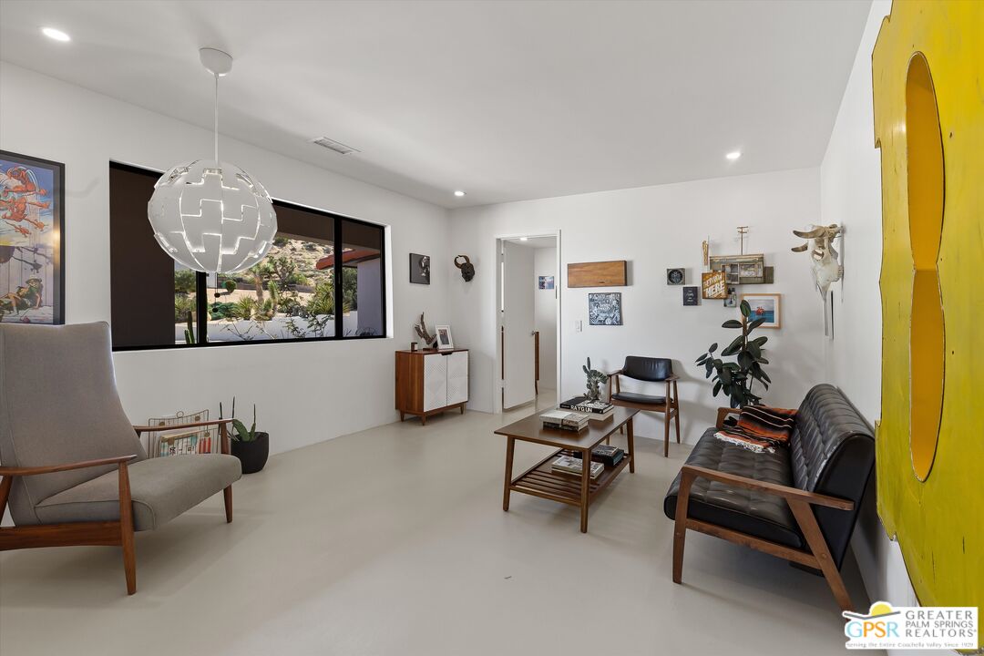 53744 Ridge Road Yucca Valley, CA 92284 - Photo 25 of 39 a living room with furniture and a flat screen tv