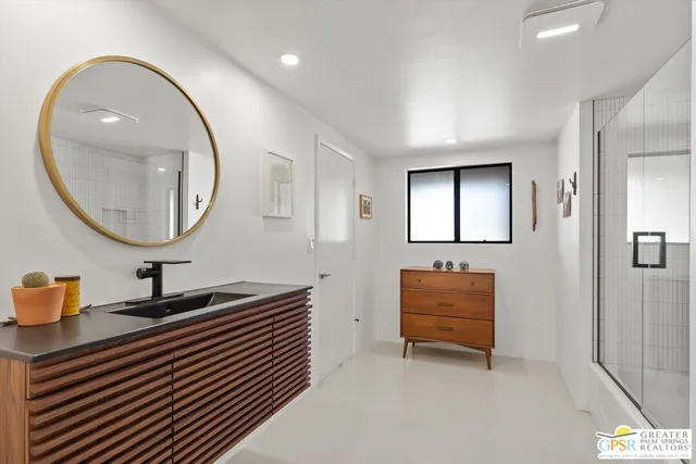 a room with a mirror and a lamp