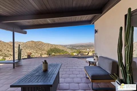 a view of living room with furniture and a floor to ceiling window