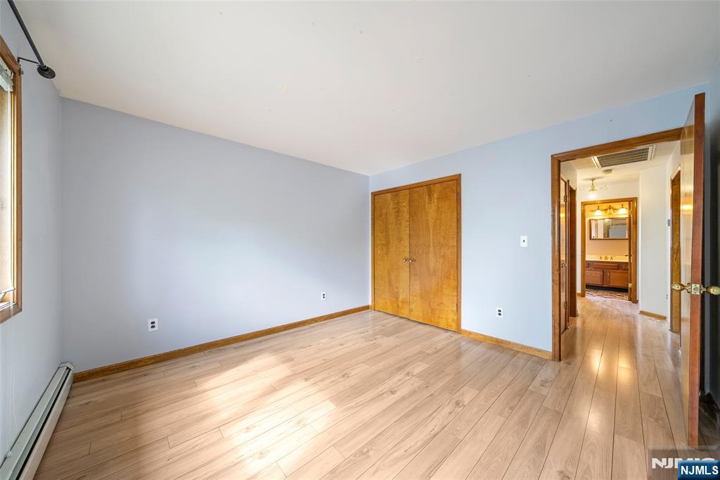 140 Allwood Road, Unit C Clifton, NJ 07012 - Photo 25 of 31 an empty room with wooden floor and closet