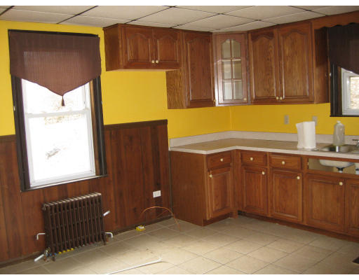 17 South Sturbridge Road Charlton, MA 01507 - Photo 16 of 26 a kitchen with wooden cabinets and a window