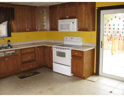 17 South Sturbridge Road Charlton, MA 01507 - Photo 17 of 26 a kitchen with a sink and a stove
