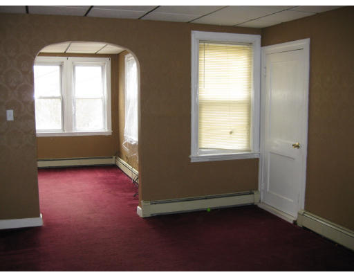 17 South Sturbridge Road Charlton, MA 01507 - Photo 8 of 26 an empty room with wooden floor and windows