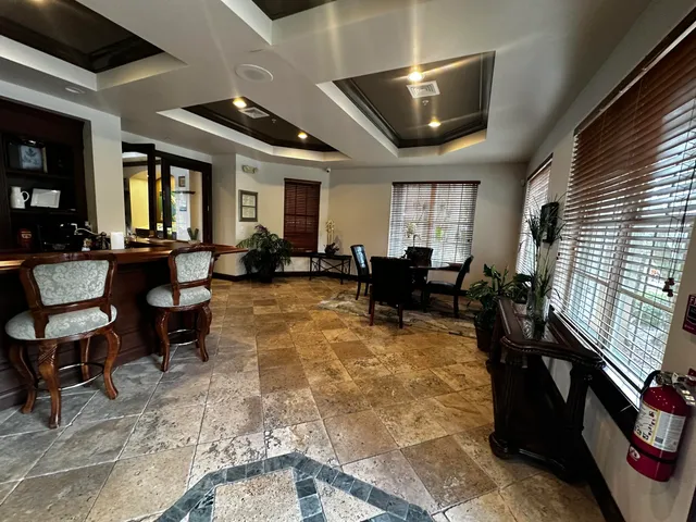 a living room with furniture large window and flat screen tv