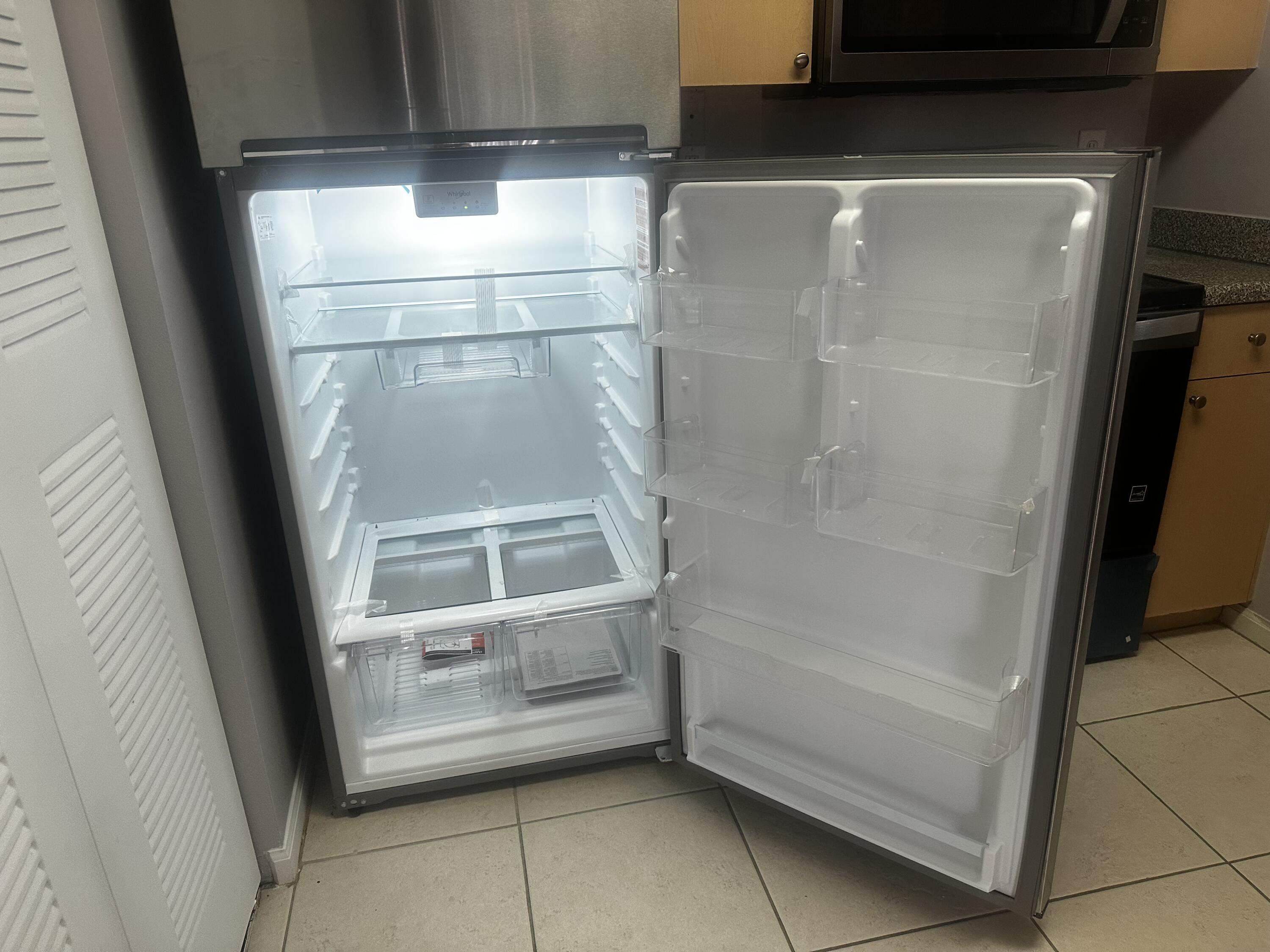 3615 Northwest Mediterranean Lane, Unit 13205 Jensen Beach, FL 34957 - Photo 2 of 14 a bathroom with a glass shower door