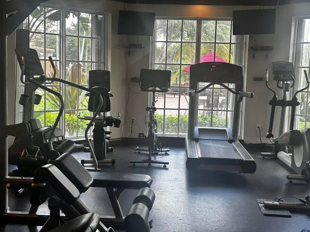a room with gym equipment and windows