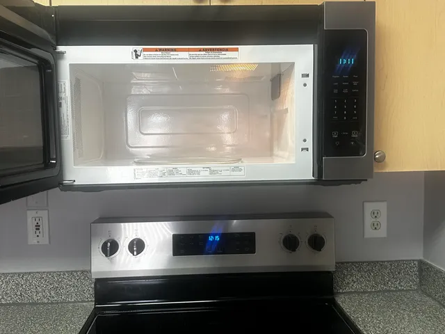 a bathroom with a stove and a microwave