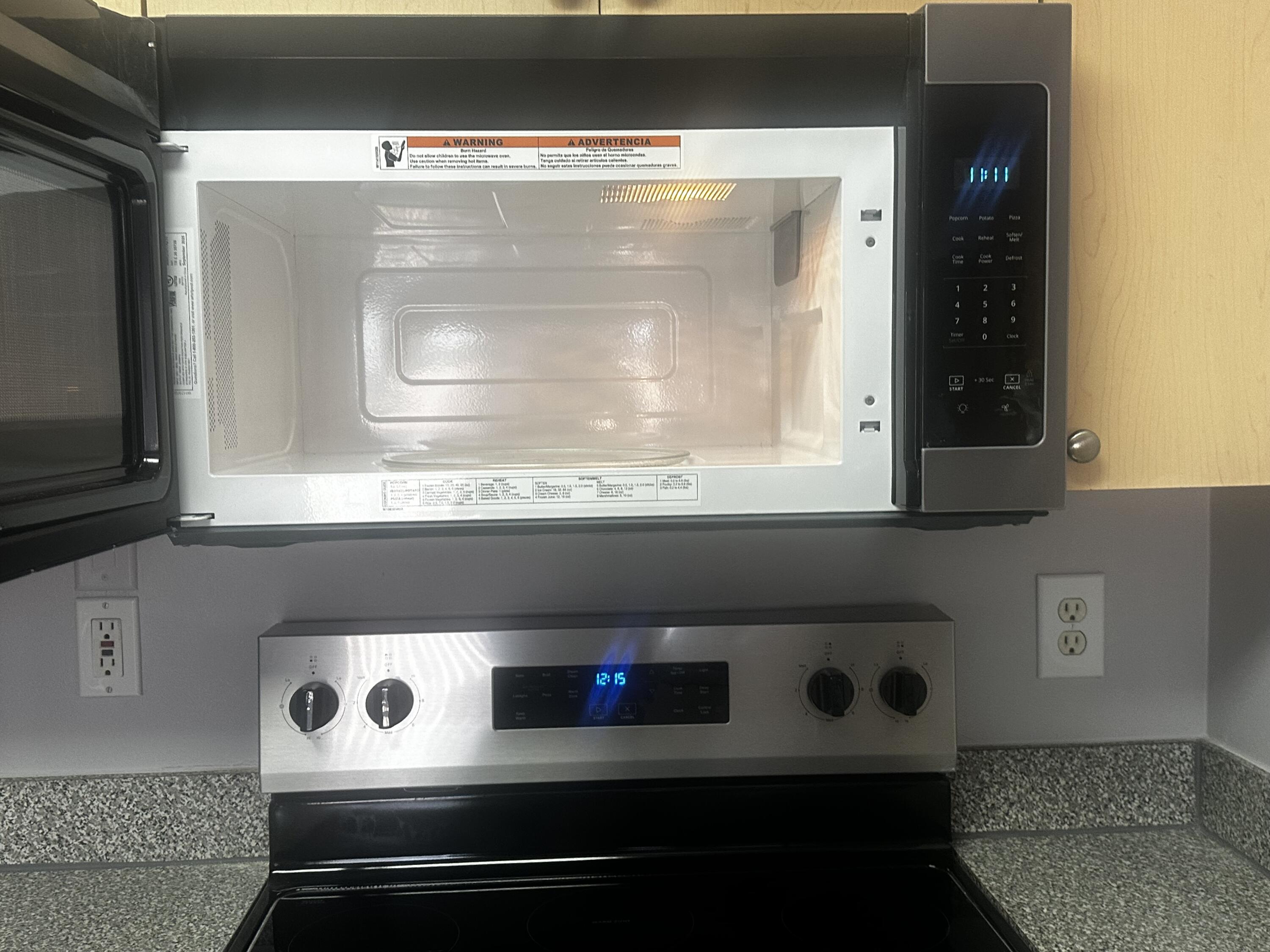 3615 Northwest Mediterranean Lane, Unit 13205 Jensen Beach, FL 34957 - Photo 7 of 14 a bathroom with a stove and a microwave