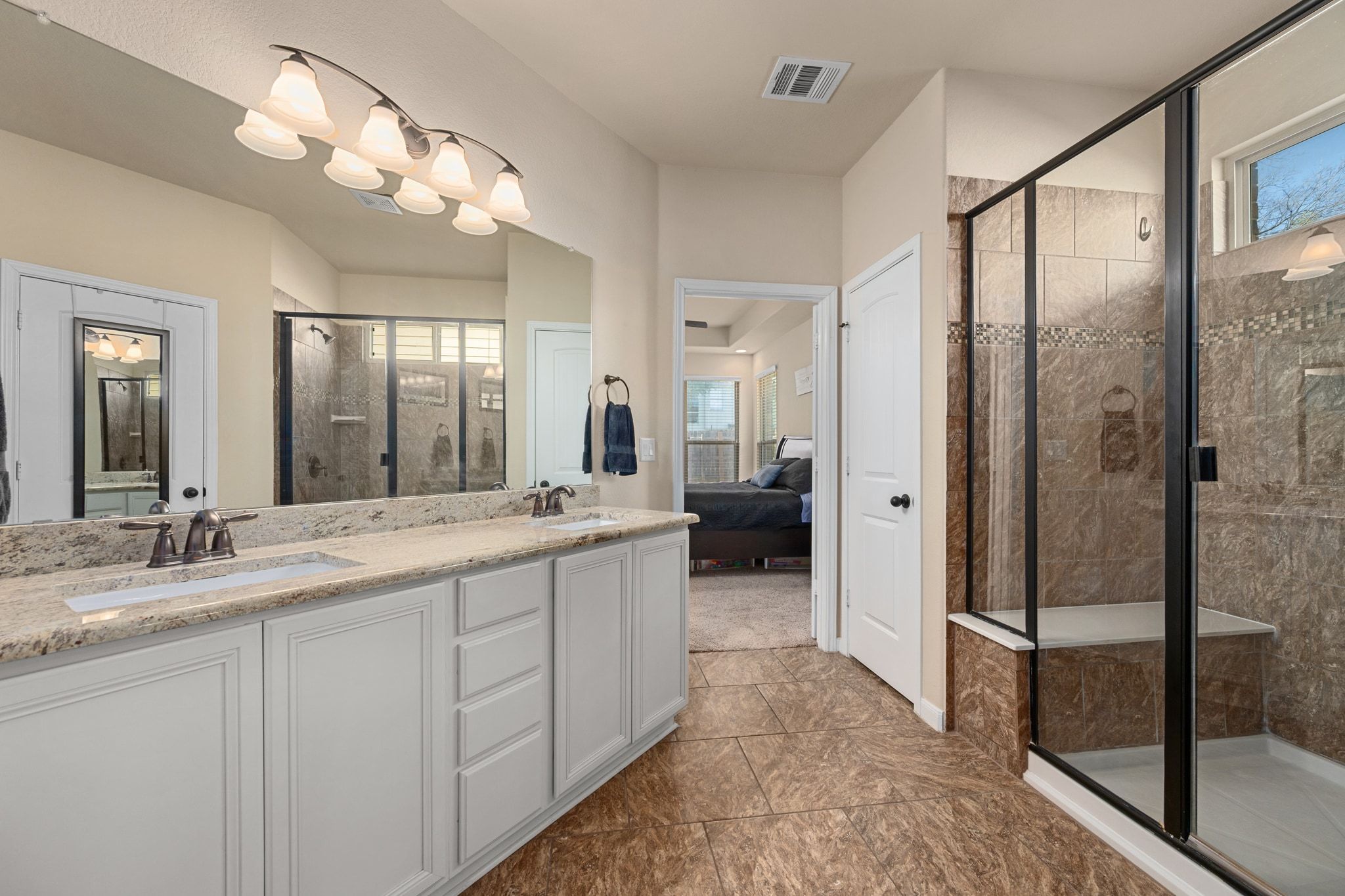 738 Palo Duro Loop Round Rock, TX 78664 - Photo 14 of 32 The walk-in shower is equipped with a bench seat for ultimate relaxation.