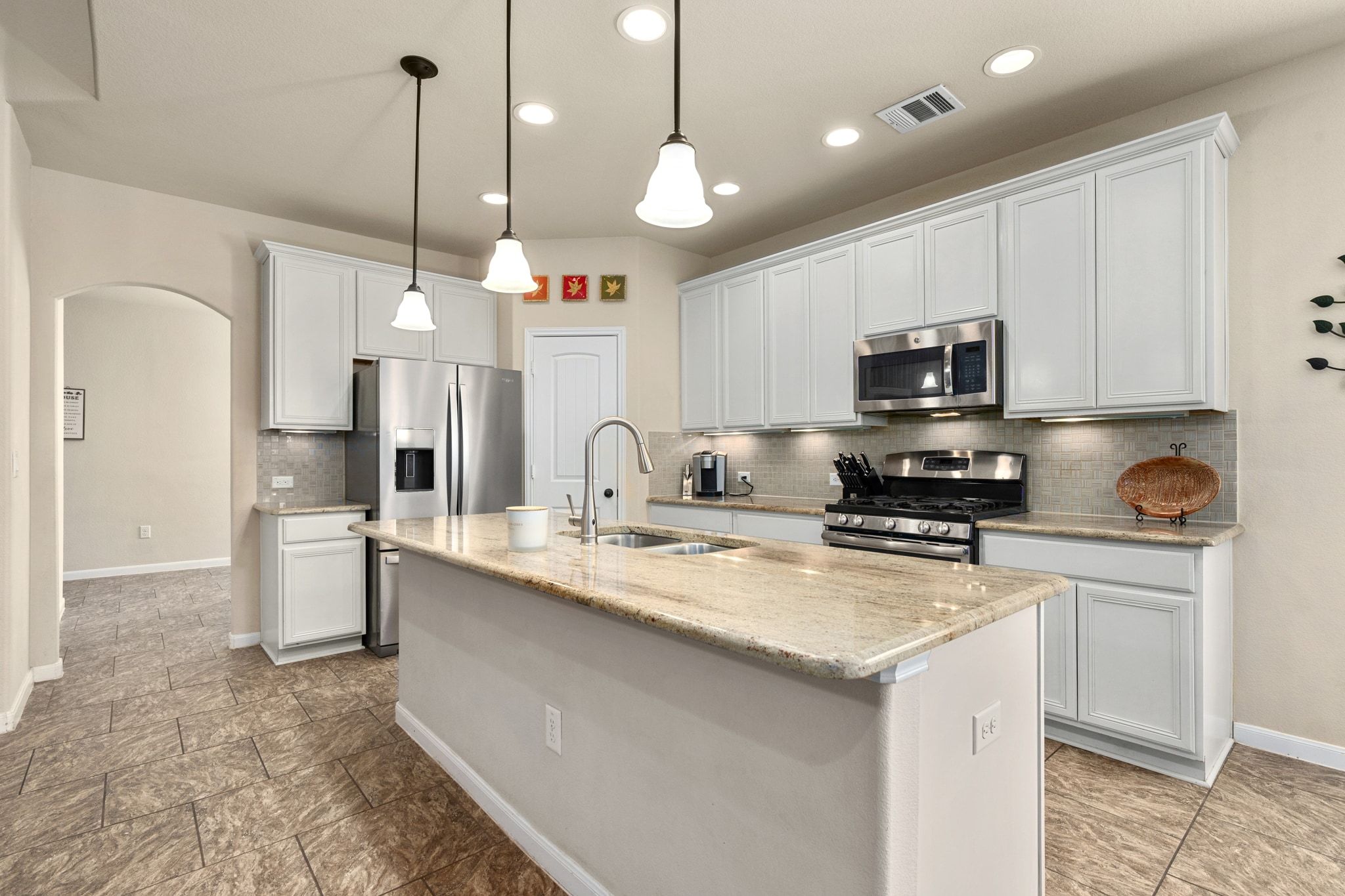 738 Palo Duro Loop Round Rock, TX 78664 - Photo 4 of 32 The open main level is centered around a large island kitchen.