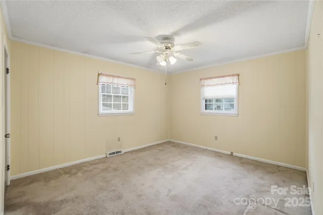 a view of an empty room with a fan
