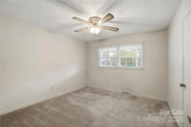a view of a chandelier fan in a room