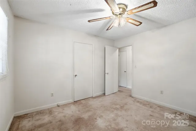 a view of a hallway with wooden floor and stairs