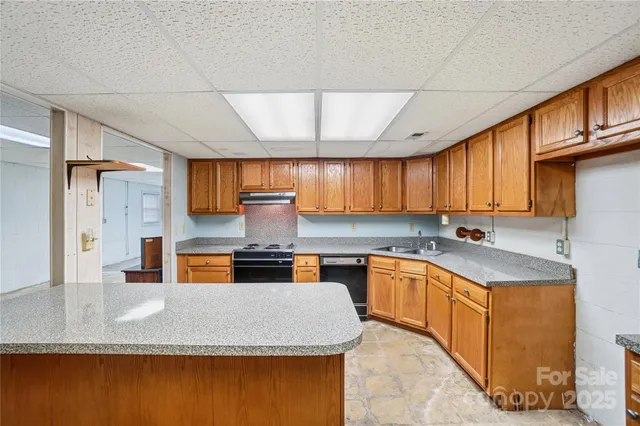 a view of kitchen with refrigerator and window