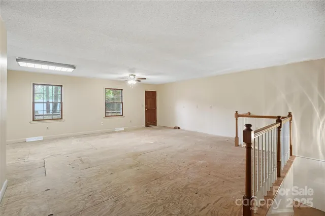 a view of an empty room with windows