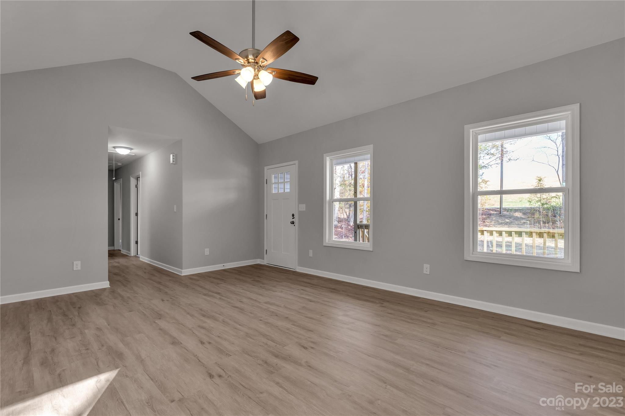 1191 Legion Road Hickory Grove, SC 29717 - Photo 11 of 32 a view of an empty room with a window and wooden floor