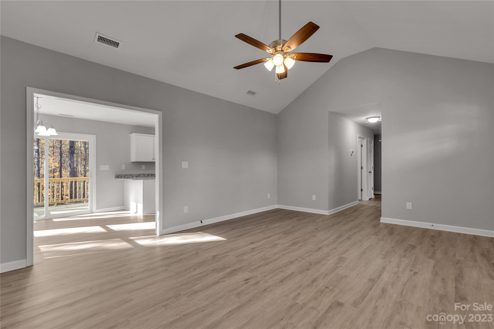 1191 Legion Road Hickory Grove, SC 29717 - Photo 12 of 32 an empty room with wooden floor and chandelier