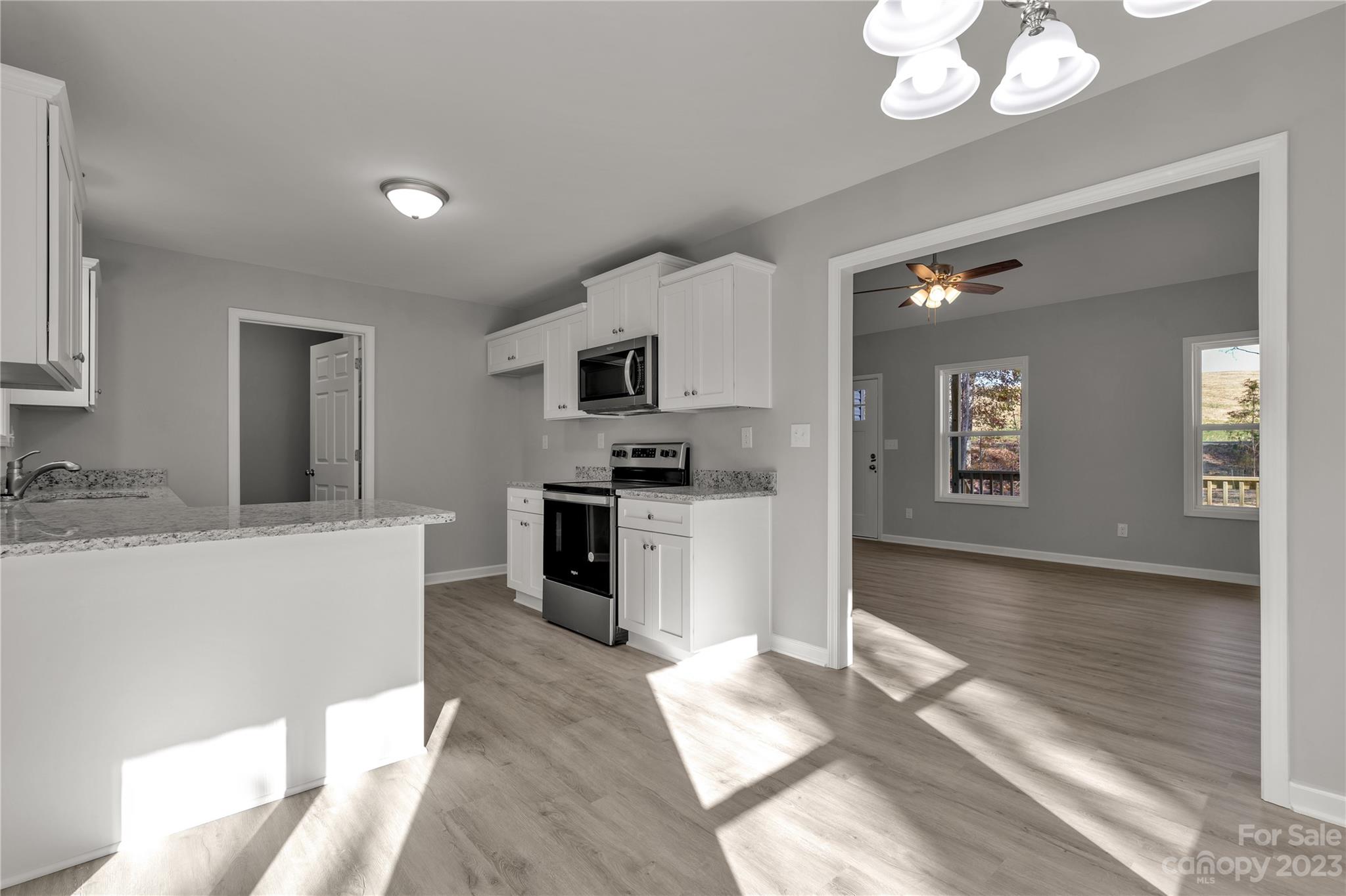 1191 Legion Road Hickory Grove, SC 29717 - Photo 14 of 32 a kitchen with granite countertop a refrigerator and a stove top oven