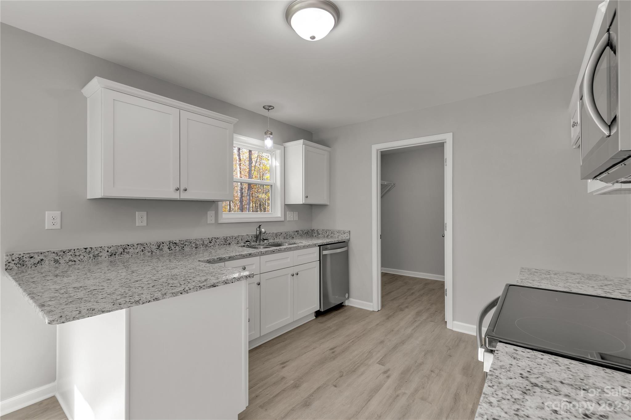 1191 Legion Road Hickory Grove, SC 29717 - Photo 15 of 32 a kitchen with granite countertop a sink and a stove top oven