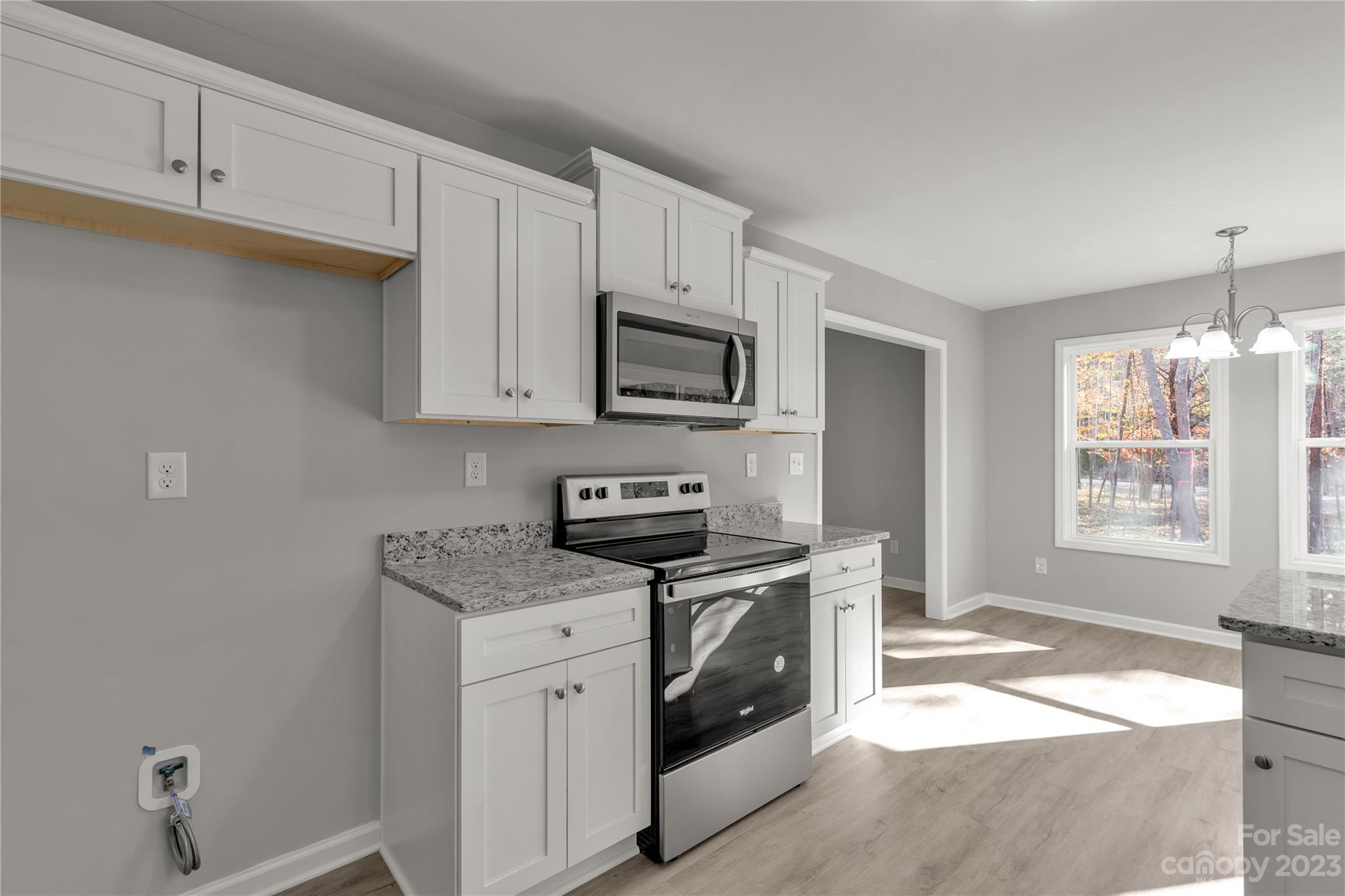 1191 Legion Road Hickory Grove, SC 29717 - Photo 16 of 32 a kitchen with stainless steel appliances granite countertop a stove a sink and a microwave