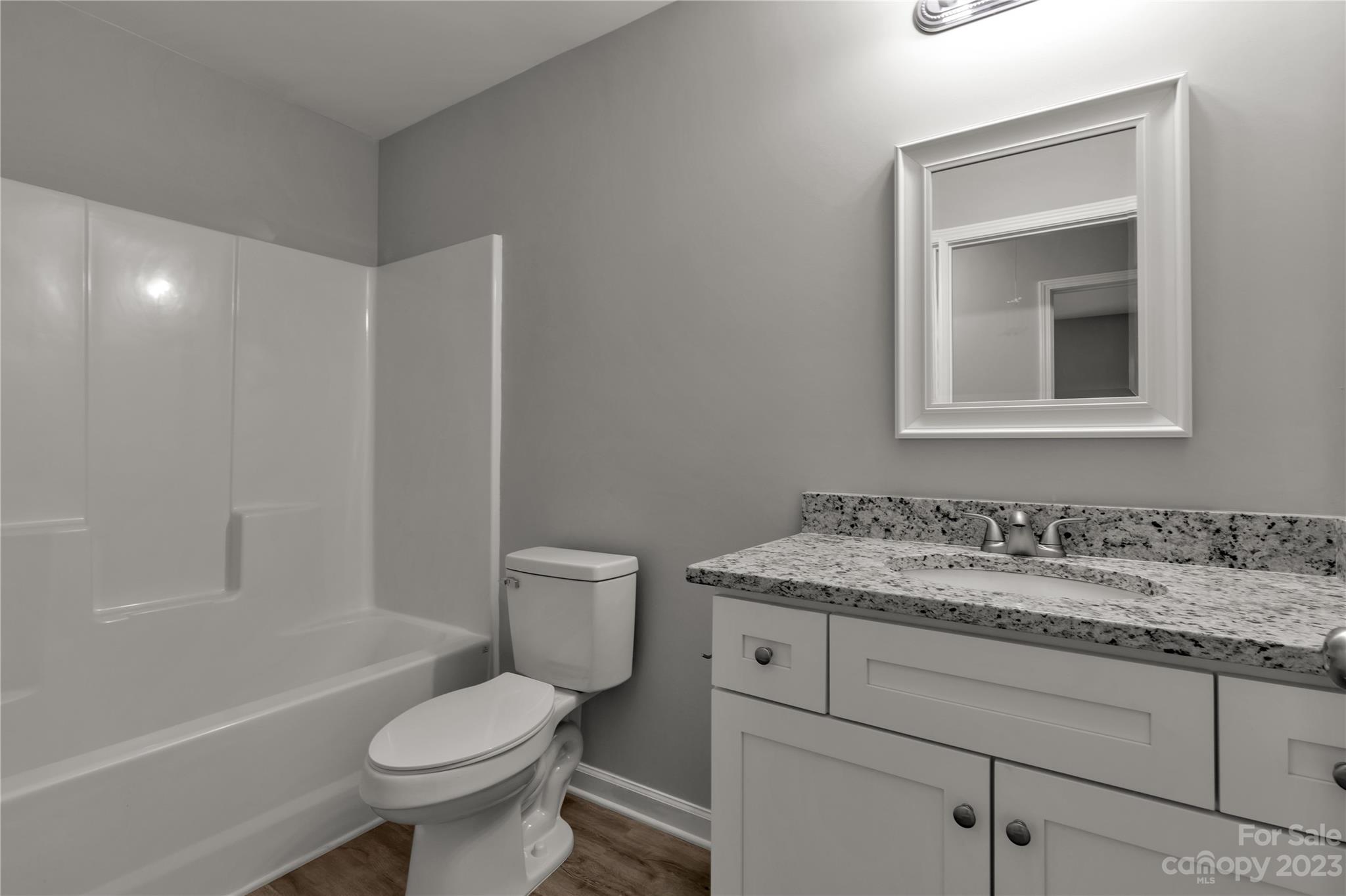 1191 Legion Road Hickory Grove, SC 29717 - Photo 19 of 32 a bathroom with a granite countertop toilet sink and mirror